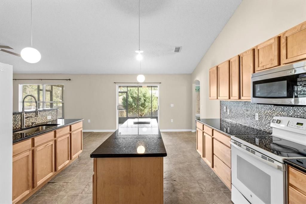 Kitchen w/ Granite Countertops, Mosaic Backsplash, 2 Pantries, Center Island & Breakfast Bar