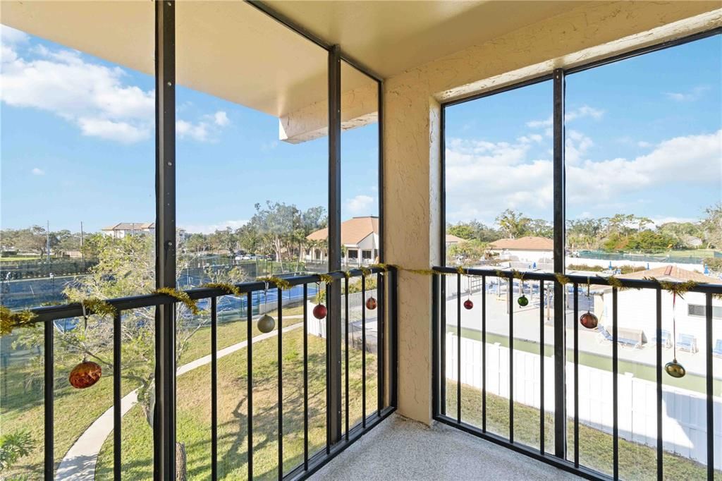 Porch overlooking tennis courts and pool