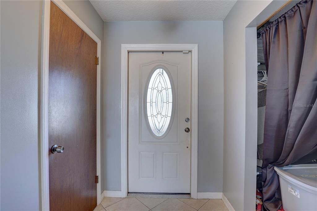 View of front door from bottom of staircase