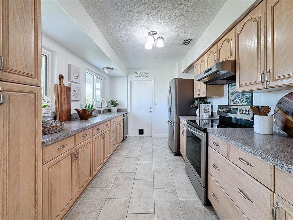 Kitchen w/ Wood Cabinetry & Stainless Steel Appliances