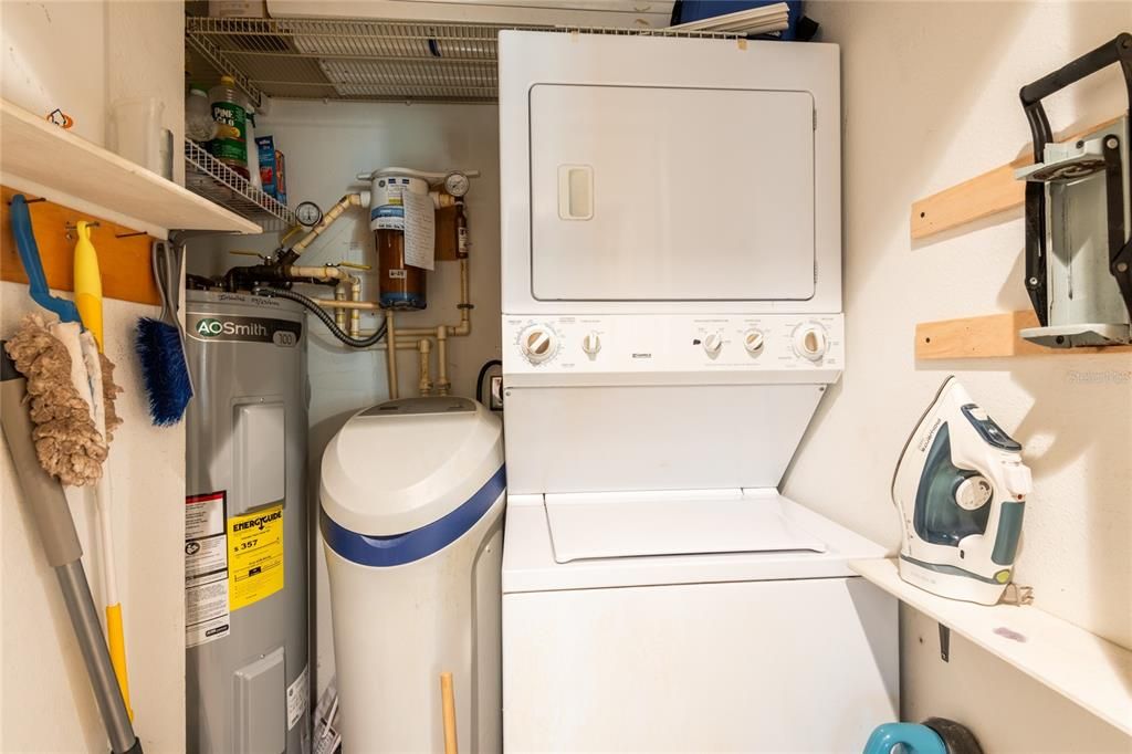 Large laundry closet with new water heater and a water softener.