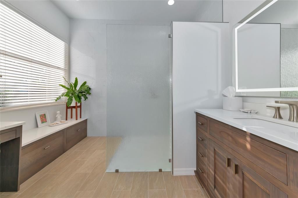 Model walk-in shower, custom cabinets & LED mirror.