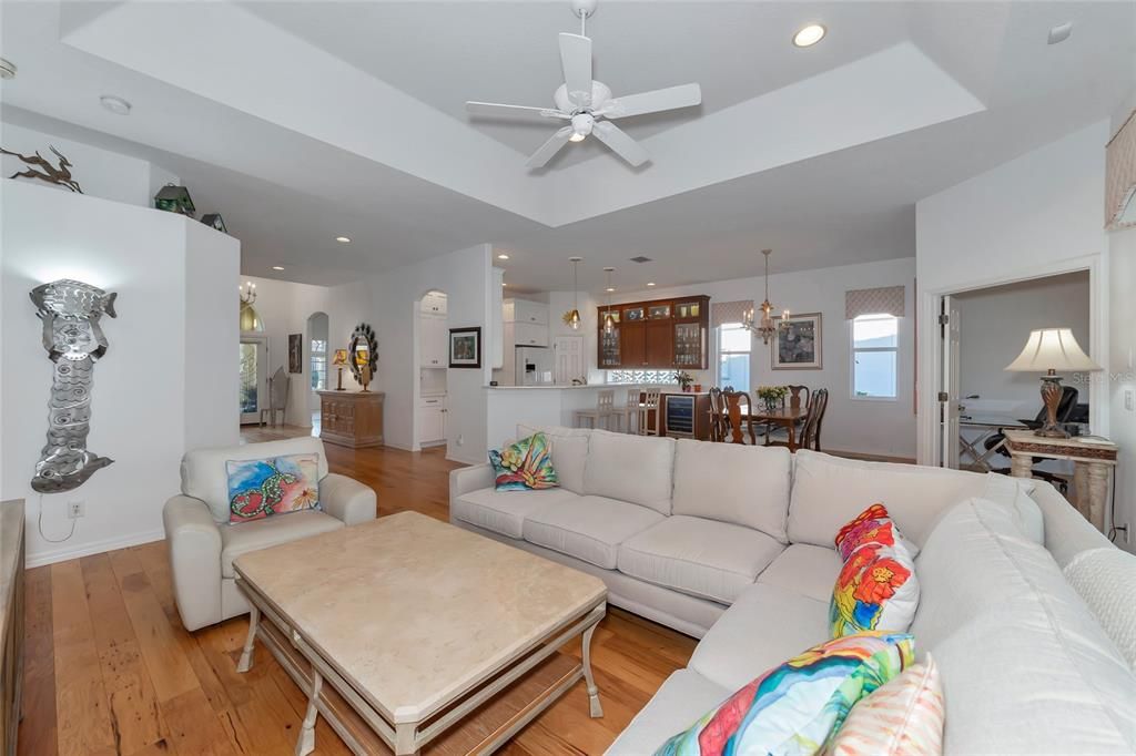 Great room w/ tray ceiling open to show kitchen & dining room.