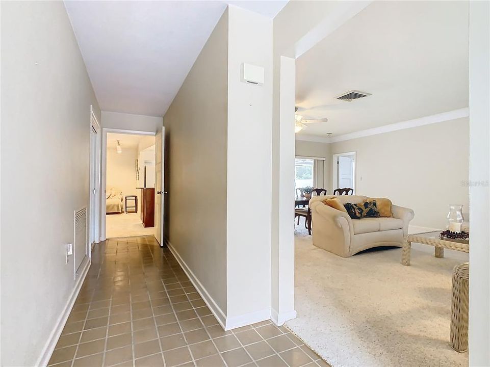 The front foyer leads to the living room/dining room to the right or continue down the hall to the family room.