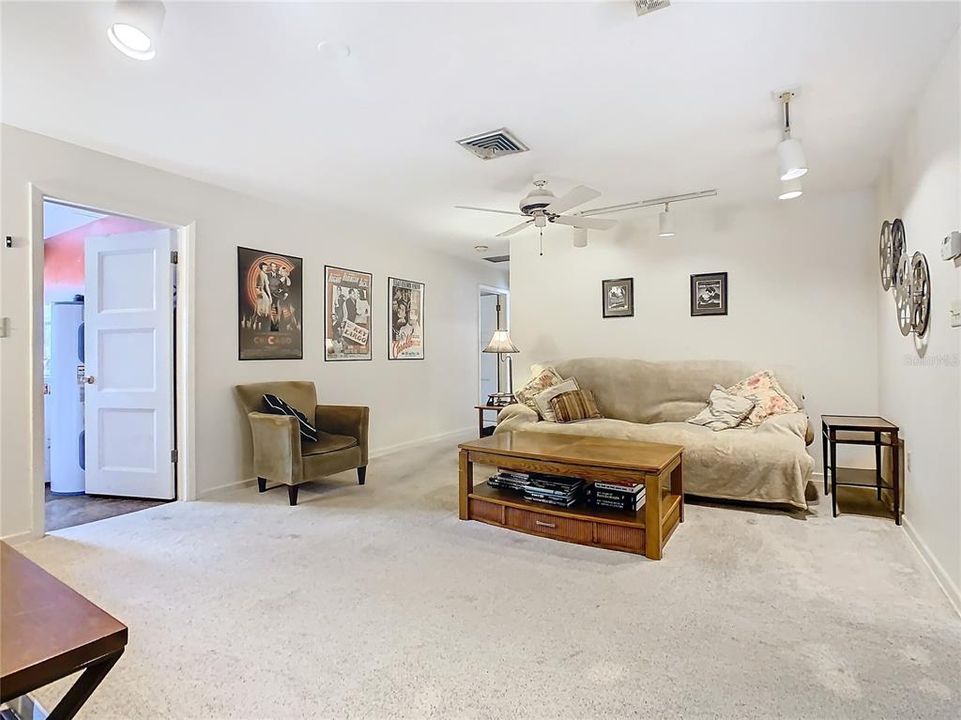 Family room.  The door on your left opens to the laundry and the hallway leads to the 2 guest bedrooms and the pool/guest bathroom.