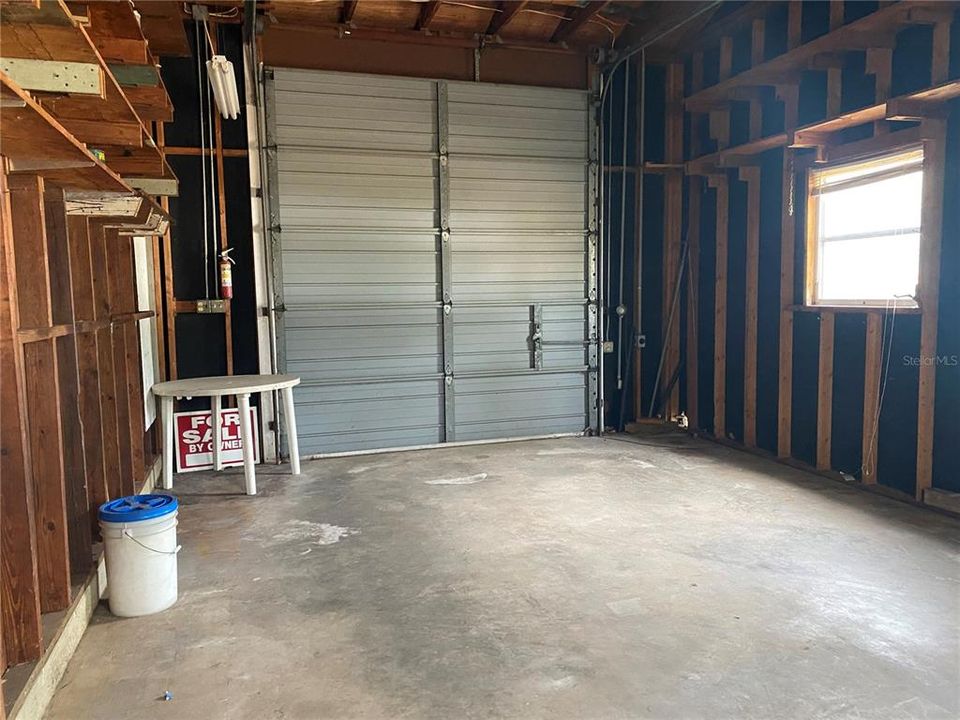 Detached 2 car garage has 2 overhead doors.