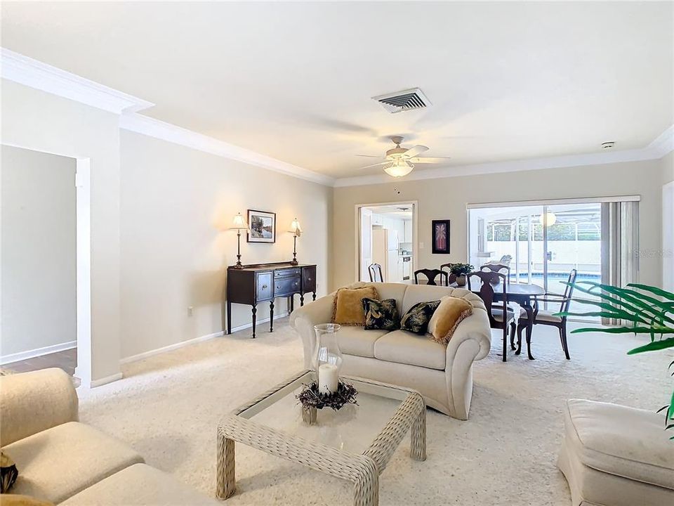 Living room / dining room with view of the pool