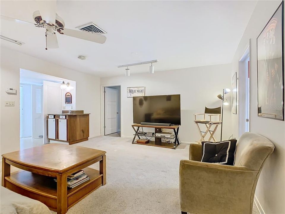 Family room - first door on the left opens to the kitchen, door at the back leads to the foyer and front door and door on the right leads to the laundry.