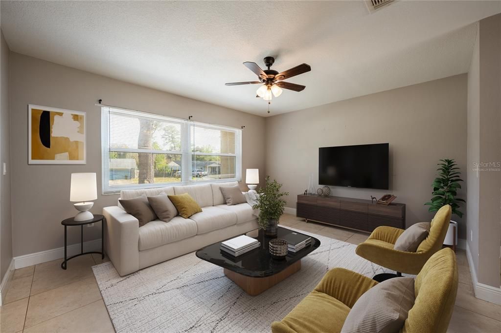 Step through the front door and into a bright and open great room, your living, dining and kitchen all flow together with easy care tile floors and large windows for great natural light! Virtually Staged.