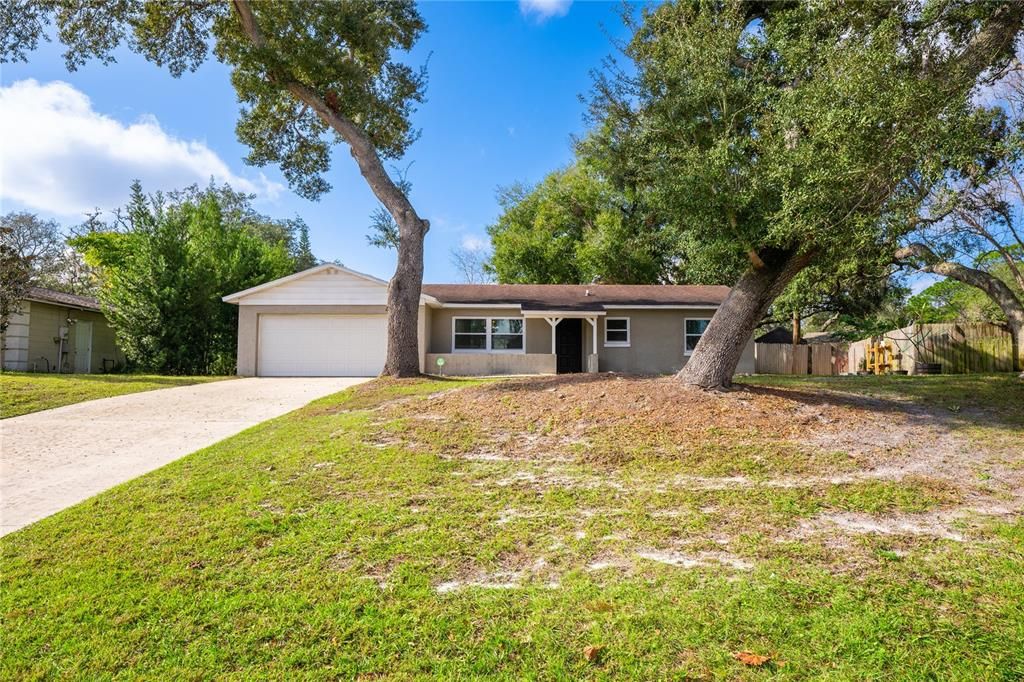 Perfectly situated between I-4, 417, and 17-92 in a quiet corner of Sanford, this 3BD/2BA home delivers a spacious lot with a fenced yard and great entertaining space, an UPDATED KITCHEN & BATHROOMS, UPDATED WINDOWS and a NEWER A/C (2021), FRESH INTERIOR PAINT (2023), a split bedroom layout and TILE & WOOD LAMINATE FLOORS throughout for low maintenance living!