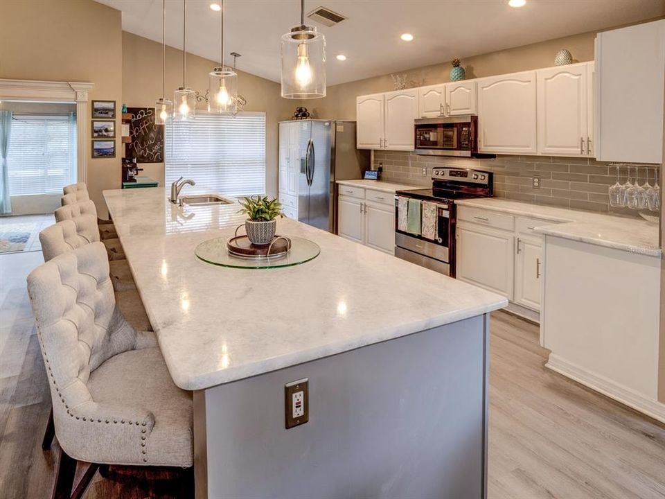 Kitchen with marble hard surface countertop.