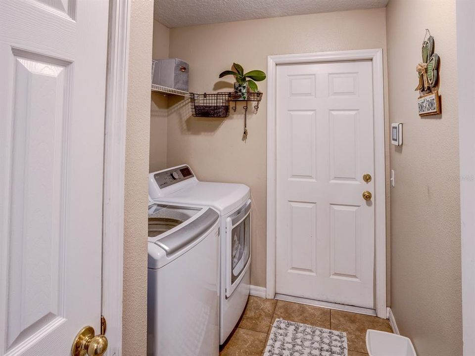 Laundry room heading to the 2 car garage.