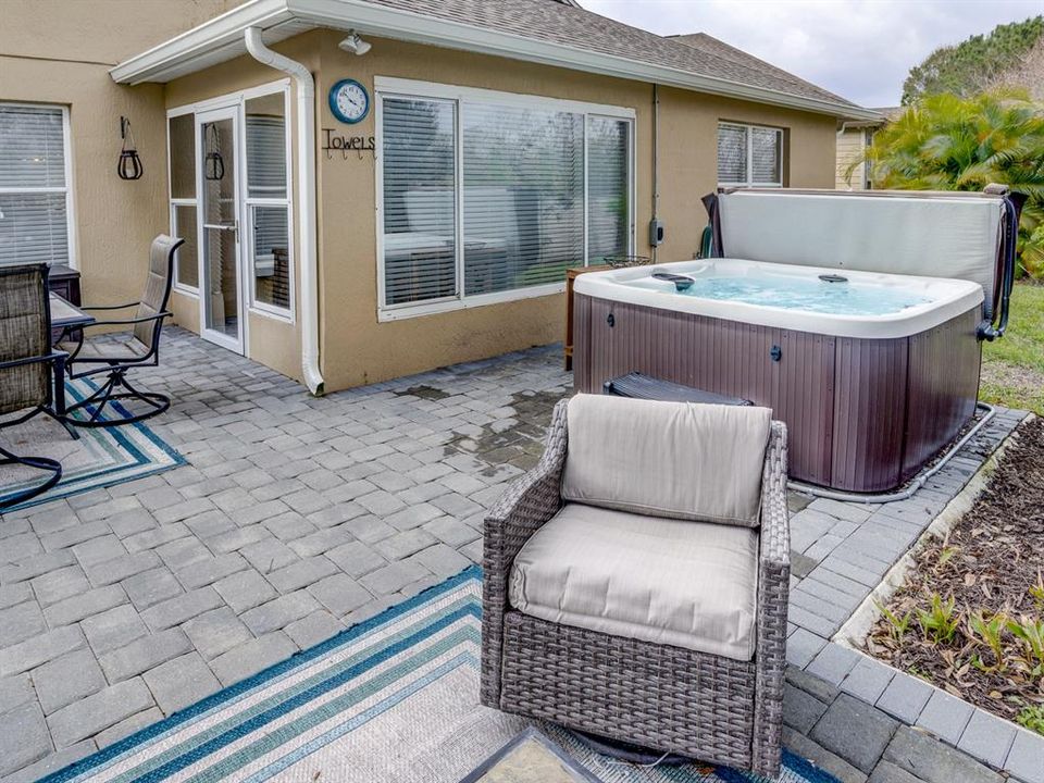 Paved patio with a hot tub for relaxation.