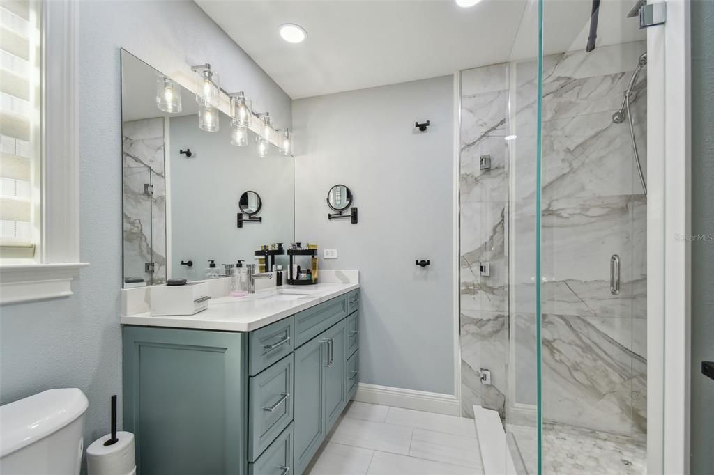 Primary suite bathroom with walk in shower