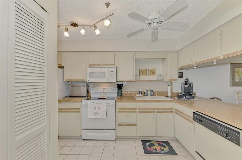 Kitchen with washer located in door on left