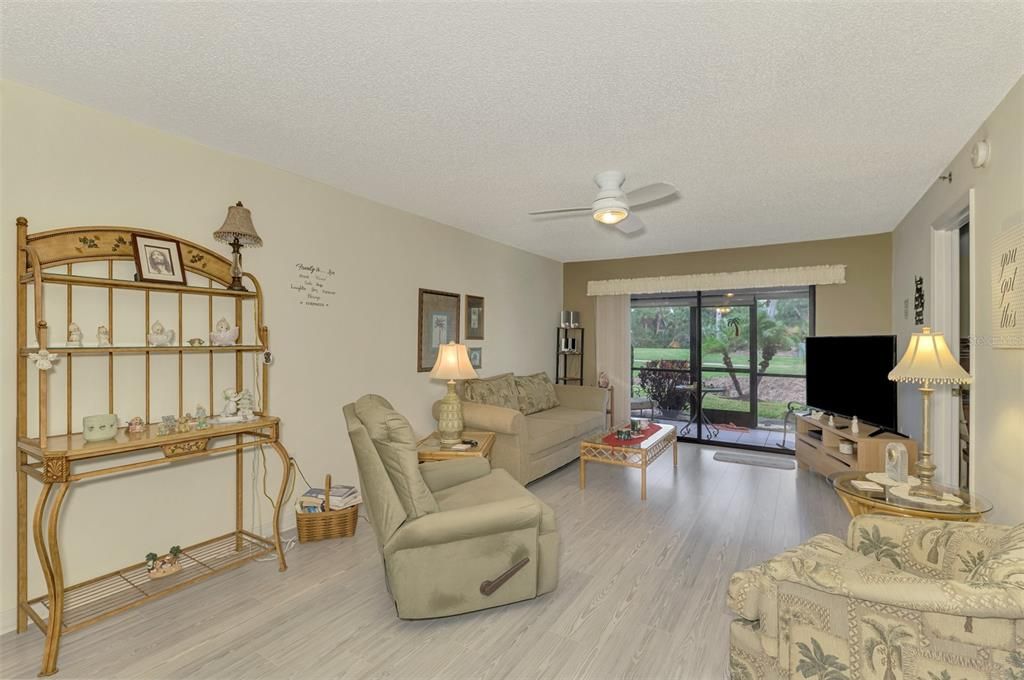 Living room looking out onto lanai and master bedroom on the right