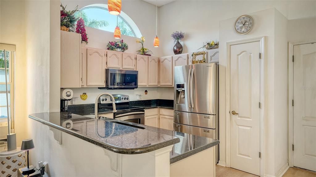 Kitchen w granite counter tops & stainless steel appliances.