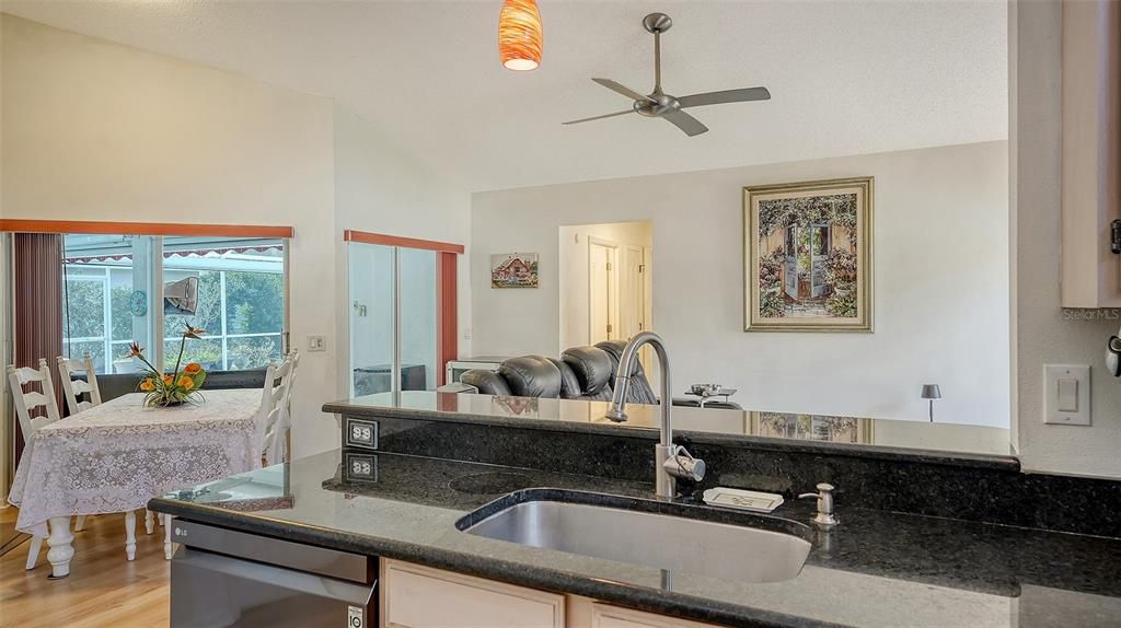 Kitchen w granite counter tops & stainless steel appliances.