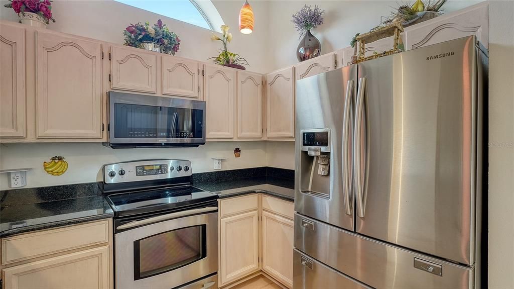 Kitchen w granite counter tops & stainless steel appliances.