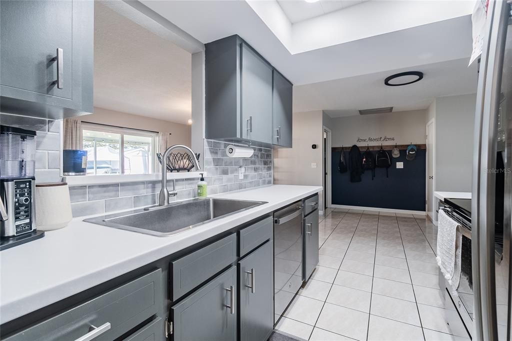 Galley Kitchen with view of access to the Primary Bedroom and Garage.