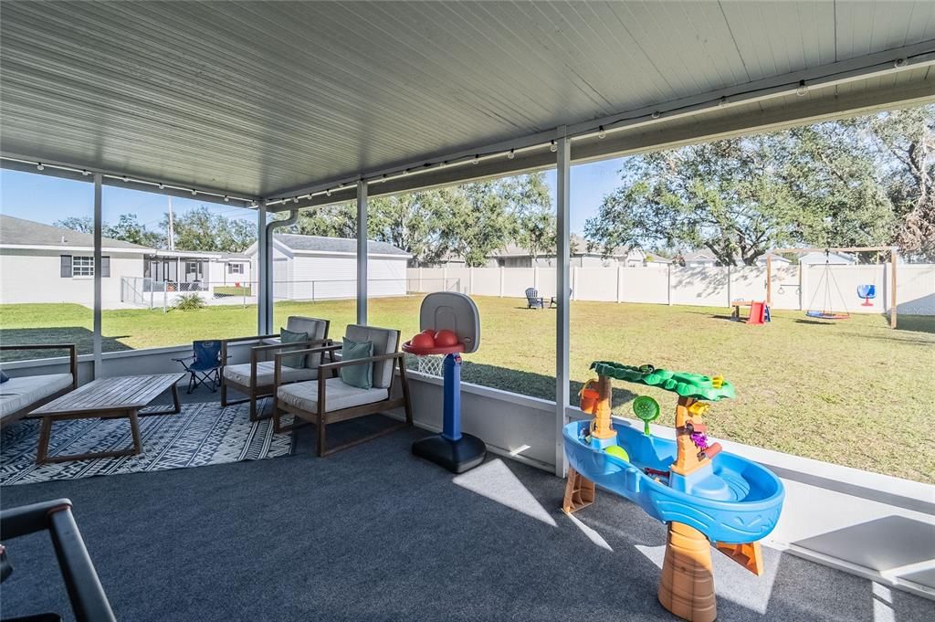 Screened patio leads out to the generous backyard.