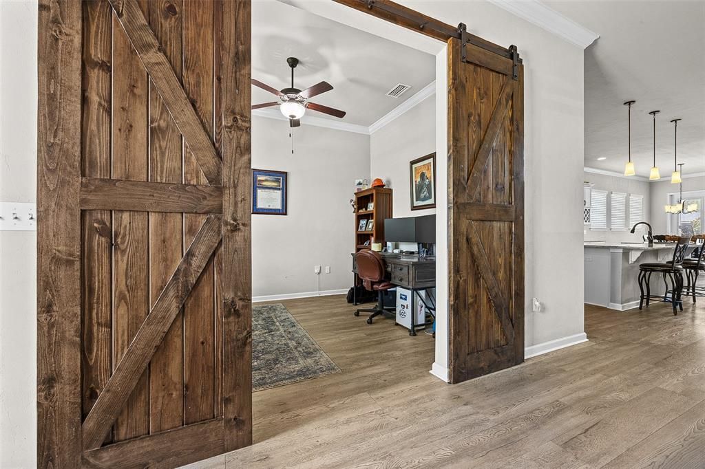 Barn doors leading to study off foyer