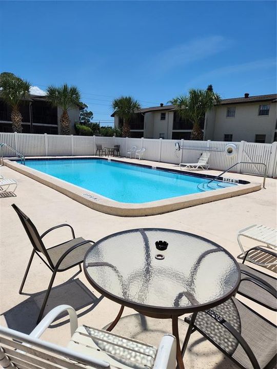 HEATED POOL HAS SEATING AND TABLES