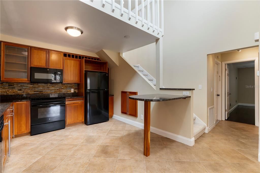 The kitchen features a breakfast bar that is ideal for a quick bite to eat or to serve your guests your favorite culinary creations.