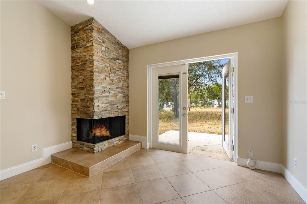 Cozy corner wood burning fireplace.