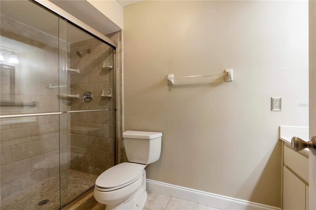 Master bath with upgraded shower with floor to ceiling tile.