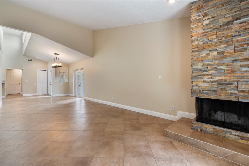 Cozy corner wood burning fireplace with hand cut stone motif in the living room