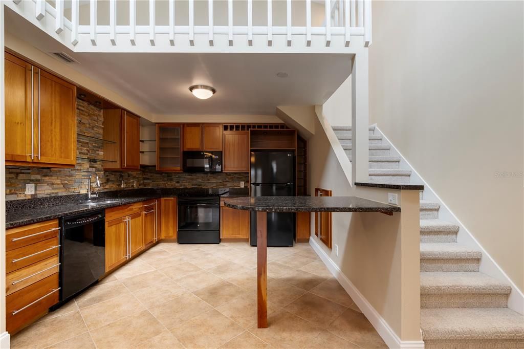 The kitchen features upgraded cabinets, granite counter tops, hand cut stone backsplash and brand new appliances.