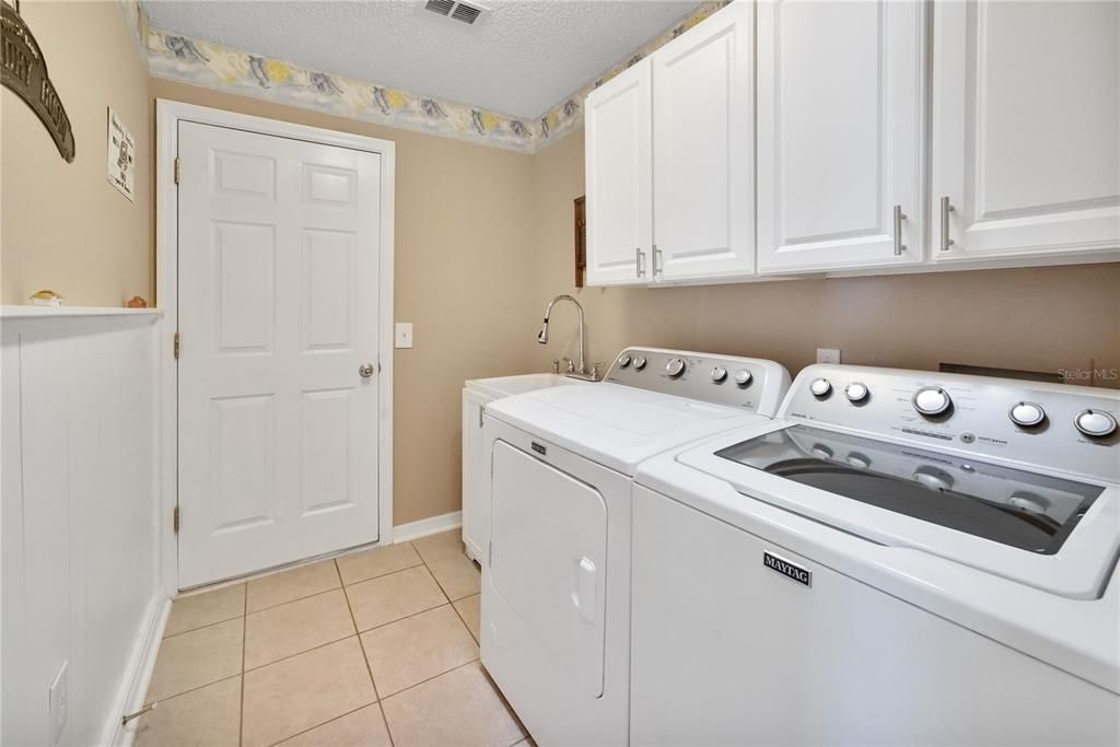 Laundry room leading into the garage