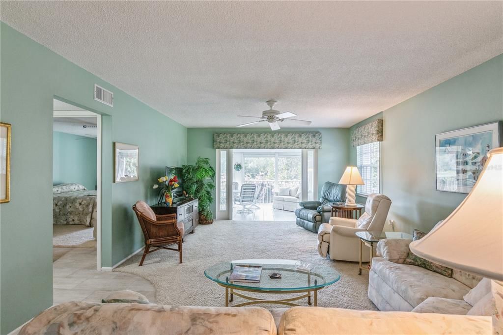 Living room out to large, enclosed lanai.