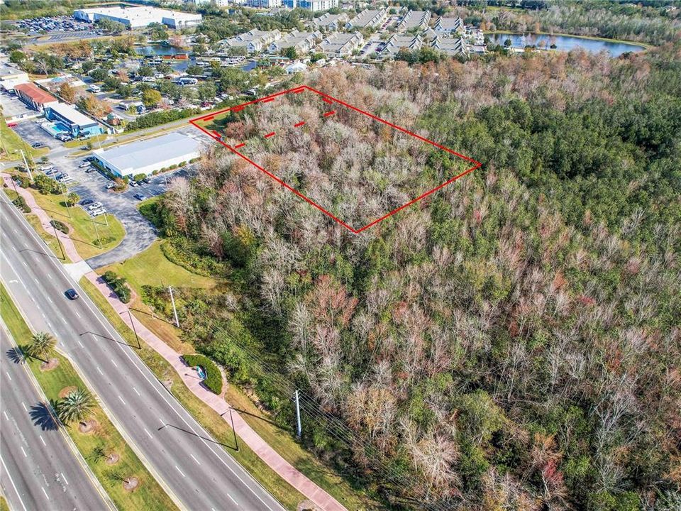 5.25 acres, right off of US 192/W Irlo Bronson Memorial Hwy. Red Dotted Lines designates approximate high and dry land, solid red line for approximate full parcel property line.