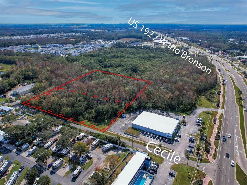 5.25 acres, right off of US 192/W Irlo Bronson Memorial Hwy. Red Dotted Lines designates approximate high and dry land, solid red line for approximate full parcel property line.