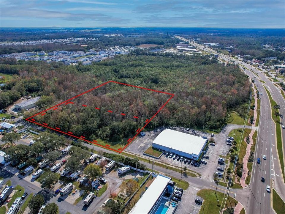 5.25 acres, right off of US 192/W Irlo Bronson Memorial Hwy. Red Dotted Lines designates approximate high and dry land, solid red line for approximate full parcel property line.