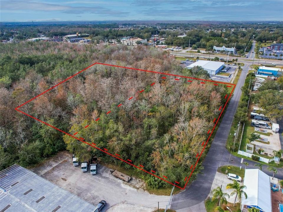 5.25 acres, right off of US 192/W Irlo Bronson Memorial Hwy. Red Dotted Lines designates approximate high and dry land, solid red line for approximate full parcel property line.