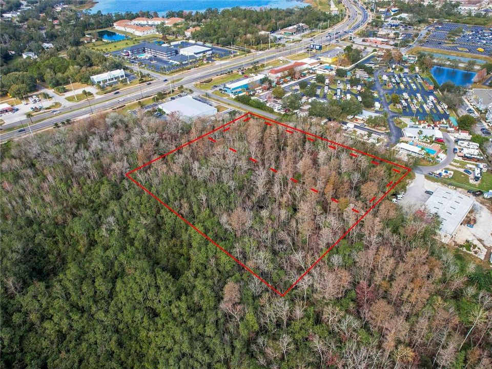 5.25 acres, right off of US 192/W Irlo Bronson Memorial Hwy. Red Dotted Lines designates approximate high and dry land, solid red line for approximate full parcel property line.