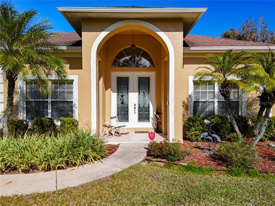 Walking up to your new front door. Imagine sitting on the porch admiring the palm trees swaying in the breeze.