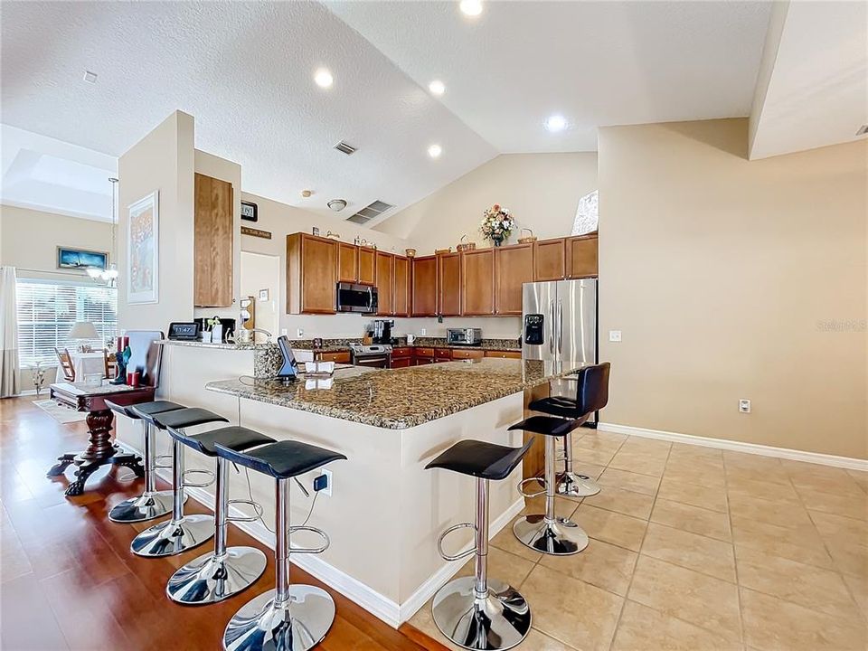 Kitche with granite countertops and stainless steel appliances.