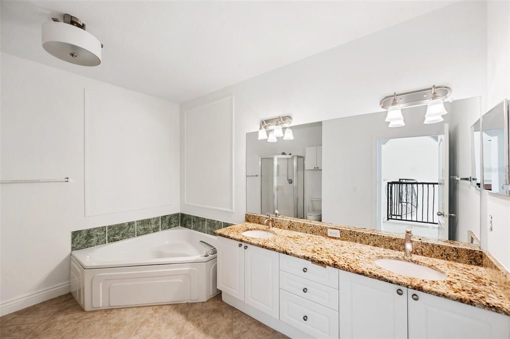 bathroom with tub, shower & dual sinks