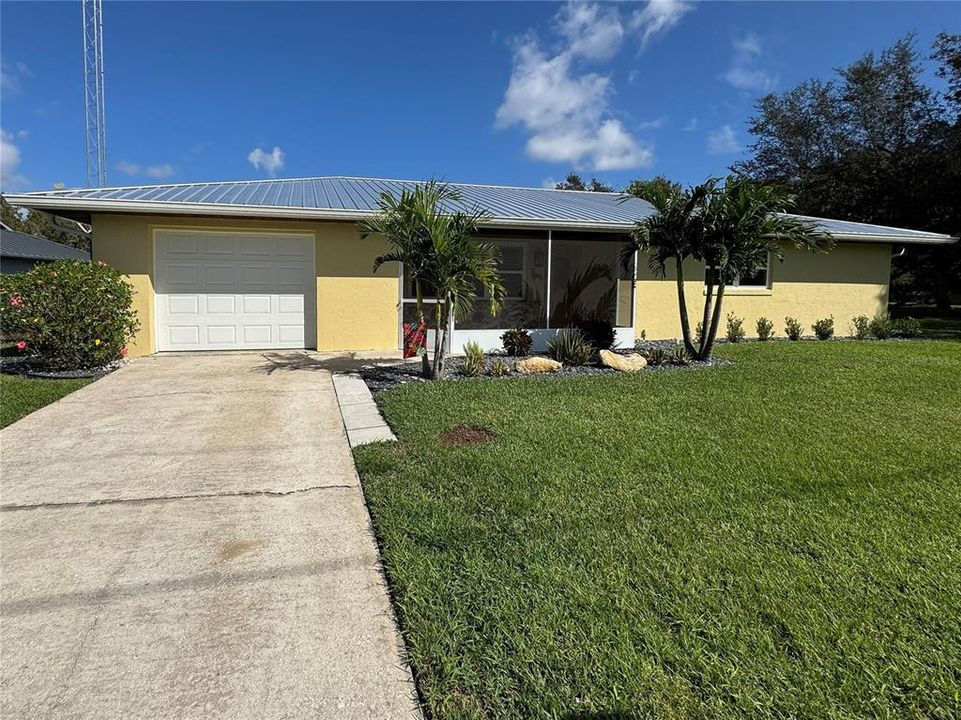 2/2 home with new metal roof, windows, flooring, and painting.