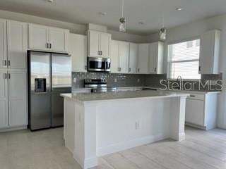 Upgraded 42" Cabinets w/Stylish Pulls, Quartz Countertops, and upgraded Stainless Steel Appliances.