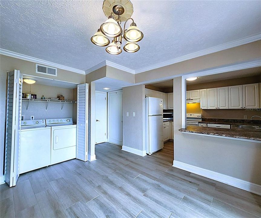 Inside laundry closet includes side-by-side washer & dryer