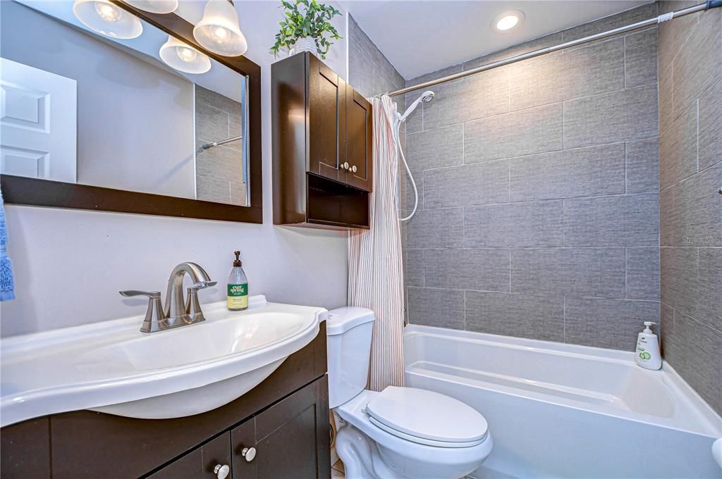 Guest bathroom with shower/ tub combo. The tub is a large soaking tub.