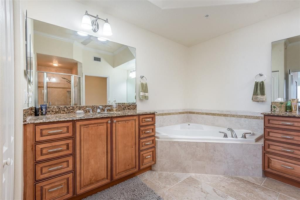 Primary Bath has two vanities and sinks separated by the jetted tub