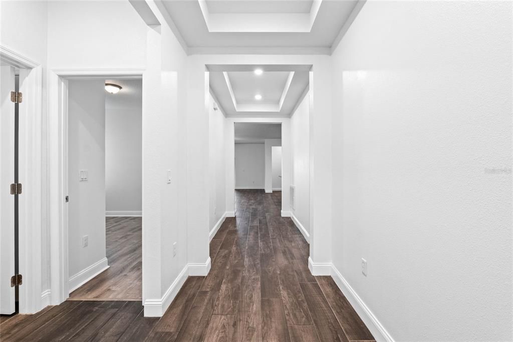 Entry hallway leads to secondary bedrooms, bathroom 3 car garage and inside laundry.
