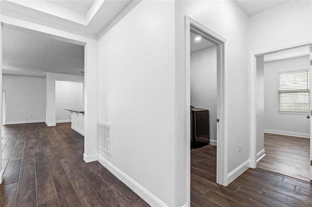 Laundry room is opposite garage entrance door.