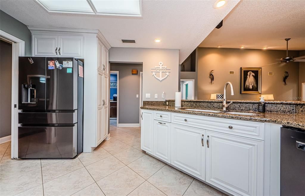 Newer refrigerator with middle drawer and lower large drawer.  Sink area in Kitchen and Dishwasher.